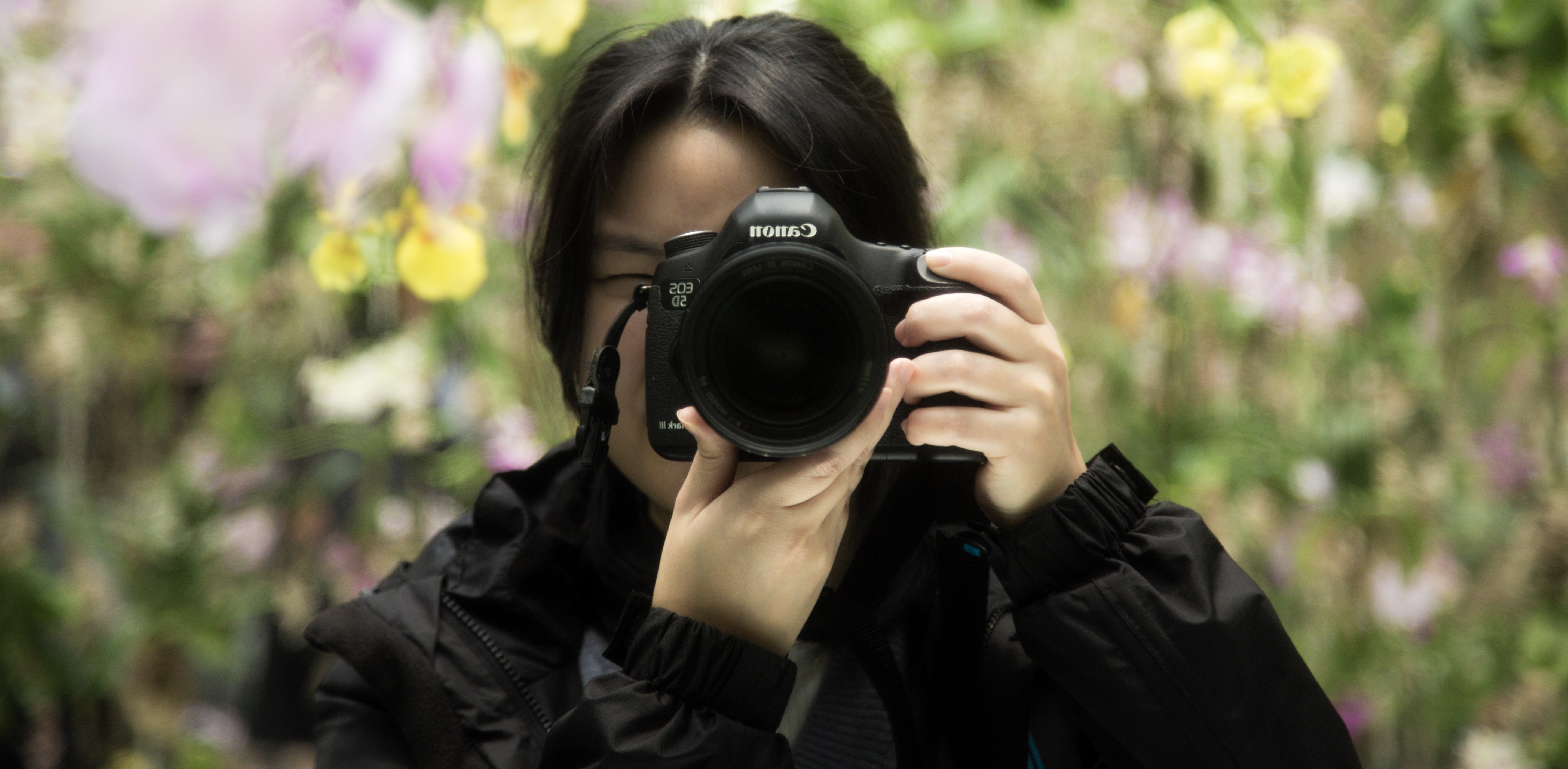 Stephanie Poon photographing among flowers